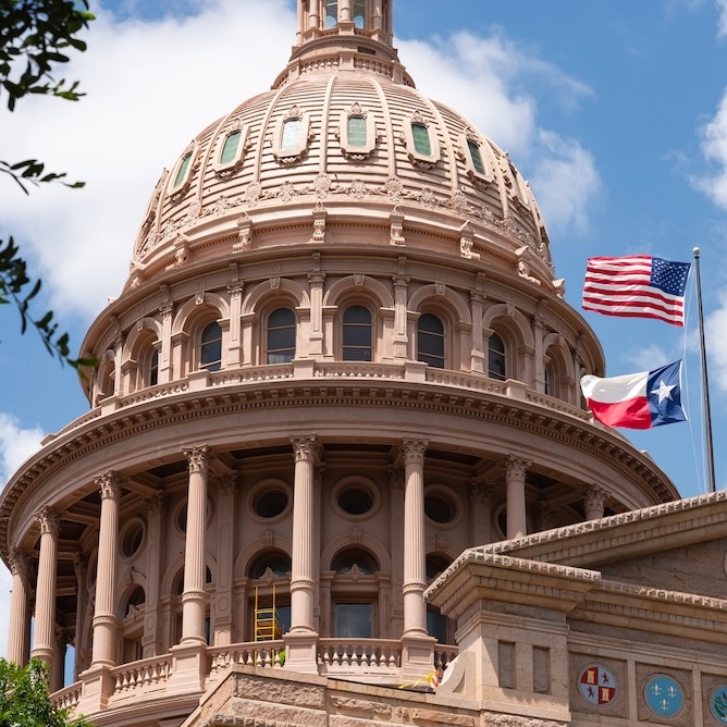Austin, Texas Capitol Building with US and Texas flags flying