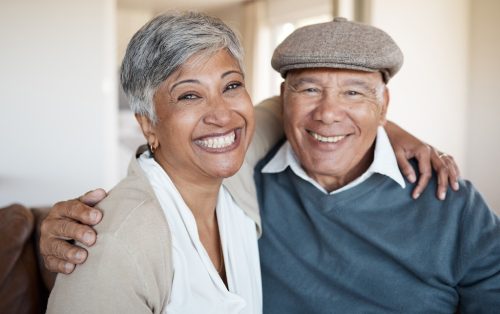 smiling couple with arms around each other